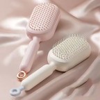 Adjustable length self-cleaning massage comb
