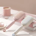 Adjustable length self-cleaning massage comb