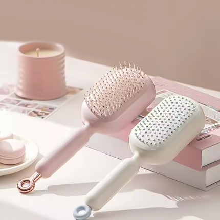 Adjustable length self-cleaning massage comb