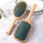 Dark green massage comb with round beech handle