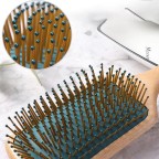 Dark green massage comb with round beech handle
