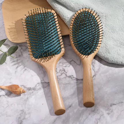 Dark green massage comb with round beech handle